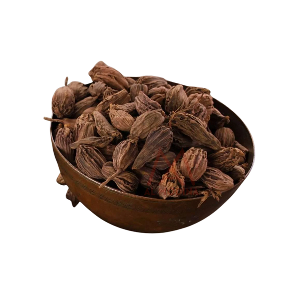 Copper bowl filled with dried black cardamom pods on black background