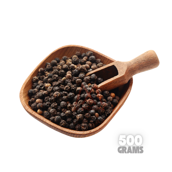Wooden scoop filled with whole black peppercorns on a wooden bowl, 500 grams label