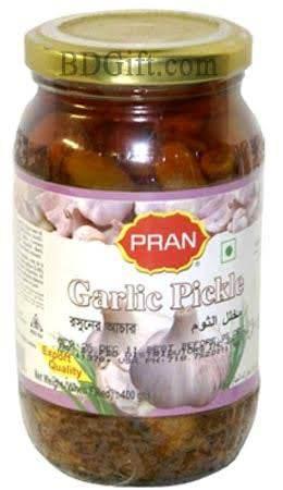 Jar of PRAN Garlic Pickle with visible garlic bulbs on label and golden lid