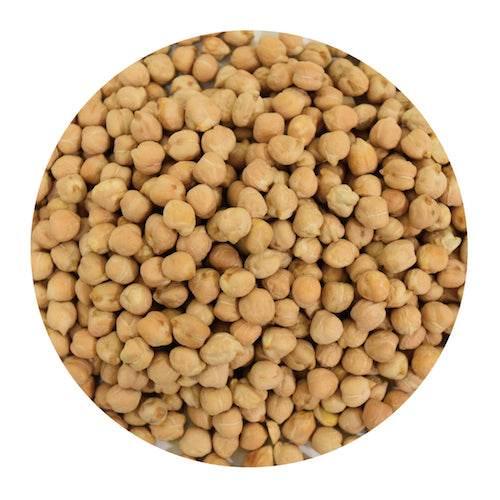 Close-up of dried beige chickpeas in a circular frame on white background