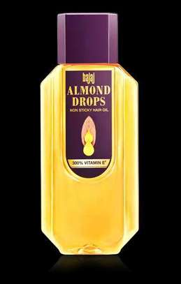 Bajaj Almond Drops non sticky hair oil bottle with 300% Vitamin E on black background