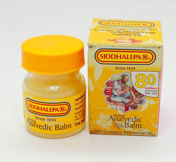 Siddhalepa Herbal Ayurvedic Balm jar with yellow cap and 80th anniversary packaging