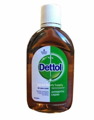 Brown bottle of Dettol antiseptic liquid with white cap and green label for herbal beauty supply