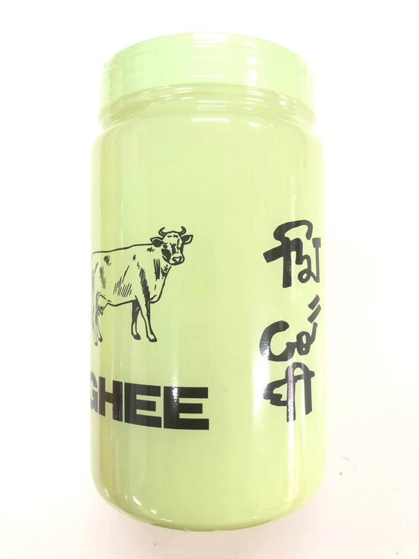 Light green ghee jar with black cow illustration and English and Hindi text on label