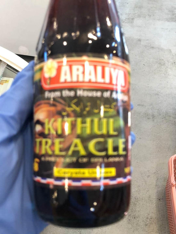 Araliya Kithul Treacle bottle held in a gloved hand, premium Sri Lankan sweet syrup