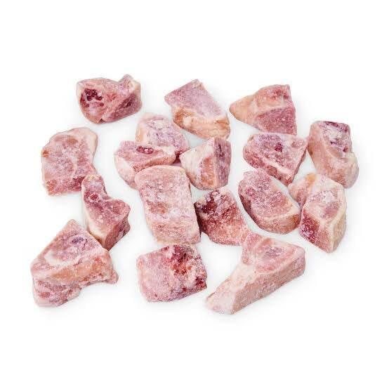 Frozen raw pork chews dog treats on white background