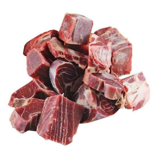 pile of raw beef oxtail chunks with marbled fat on white background
