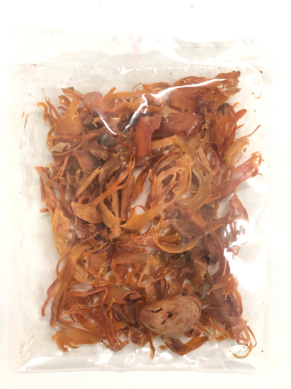 clear plastic bag filled with dried mace spice strands on white background