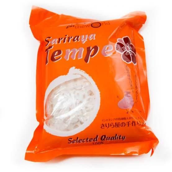 Orange package of Sariraya Tempeh with clear window showing white tempeh inside, labeled selected quality
