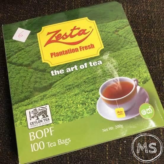 Zesta Plantation Fresh BOPF black tea box with 100 tea bags, featuring green tea plantation and steaming cup