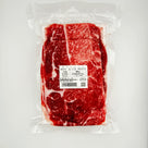 Vacuum-sealed 500g package of Wagyu beef slices with marbling and label on white background