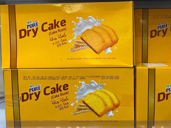 ACI Pure Dry Cake Cake Rusk yellow packaging with three cake slices and milk splash graphic