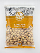 Ambika brand packaged pistachios with shells, featuring an Indian market illustration on top