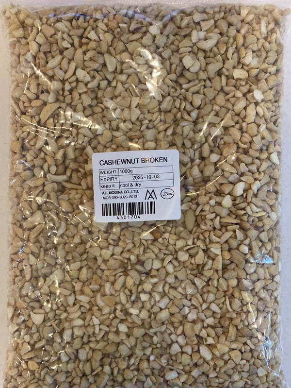 1kg pack of broken cashew nuts in clear plastic bag with label showing expiry date and storage instructions