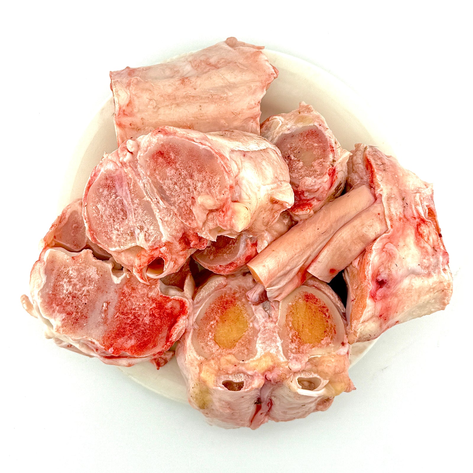 Raw beef paya on a white plate