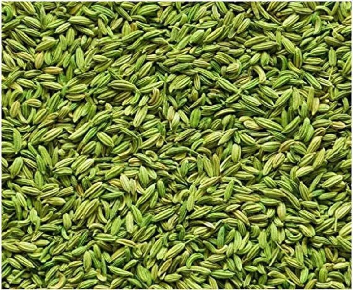 Close-up of fresh green fennel seeds densely packed, showing detailed texture and color