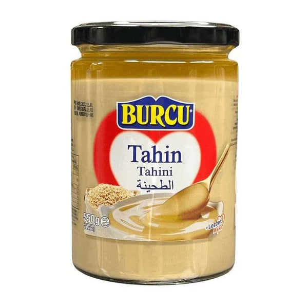 Jar of Burcu brand tahini with sesame seeds and spoon, 550g, creamy sesame paste