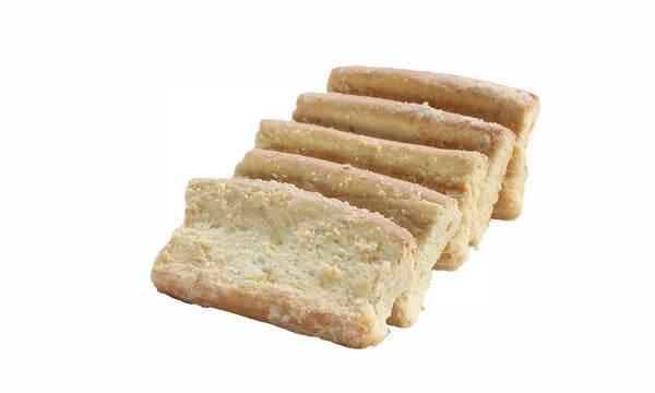 Rows of crumbly shortbread cookies on white background, classic buttery biscuit