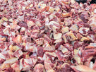 Close-up view of fresh raw beef chunks with fat and connective tissue