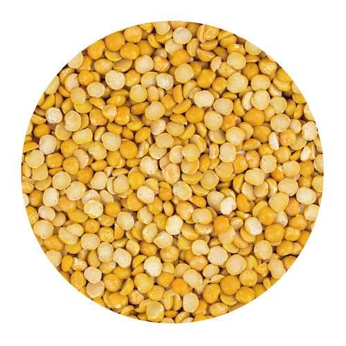 Close-up of yellow split peas texture in a circular frame on white background