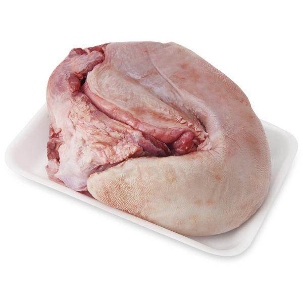 Raw whole beef tongue on white foam tray isolated on white background