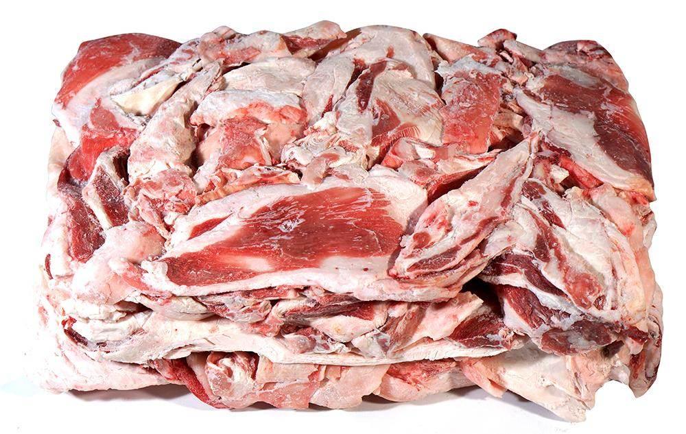 Frozen mutton fat slabs with visible red meat and white fat layers stacked on white background