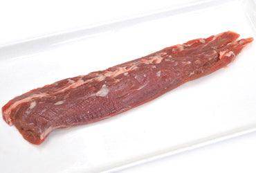 Raw whole beef tenderloin on white tray, fresh red meat cut for cooking