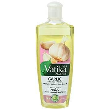 Vatika Naturals Garlic Enriched Hair Oil bottle promoting natural hair growth with garlic and mint design