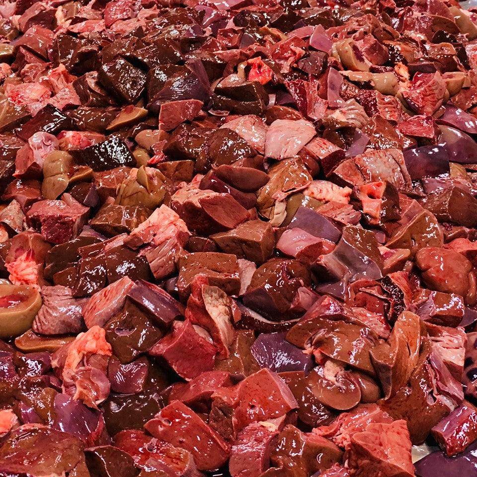 Close-up of assorted fresh raw organ meats including liver and heart pieces