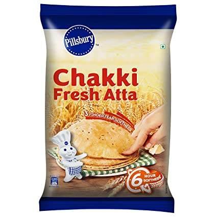 Pillsbury Chakki Fresh Atta flour package with wheat and hand holding soft roti bread