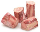 Four pieces of raw beef marrow bones for bulalo stew on white background