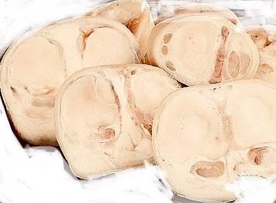 Close-up of several slices of fresh white fungus mushroom with soft texture.