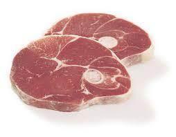 Two raw lamb shoulder chops with bone, fresh red meat slices isolated on white background