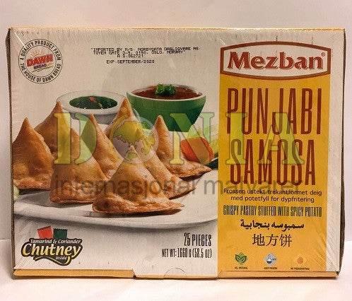 Mezban Punjabi Samosa box showing crispy triangular pastries with tamarind and coriander chutney on white plate