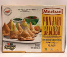 Mezban Punjabi Samosa box showing crispy triangular pastries with tamarind and coriander chutney on white plate