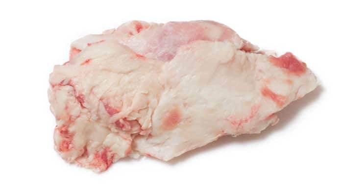 Raw beef kidney fat with white and pink marbling on white background