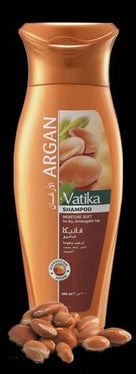 Vatika Argan shampoo bottle for sensitive scalp with argan nuts on black background