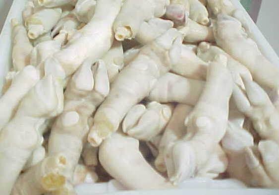 pile of raw sheep feet in a white container, fresh sheep trotters for cooking
