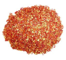 pile of crushed red chili flakes on white background, spicy dried pepper flakes