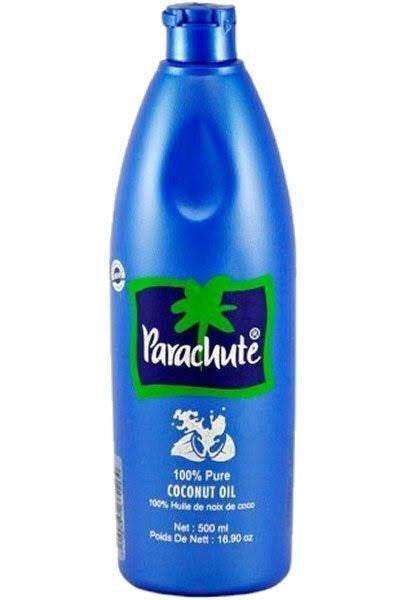 Blue bottle of Parachute 100% pure coconut oil, 500 ml, with green palm tree logo