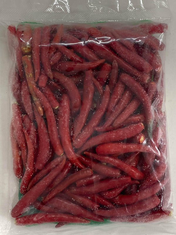 clear plastic bag filled with frozen red chili peppers covered in ice crystals