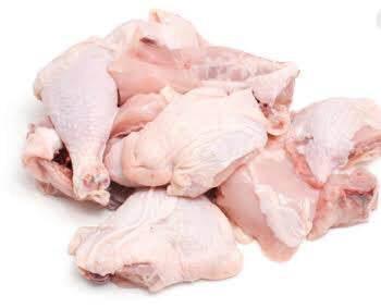 Raw chicken pieces including drumsticks, thighs, and wings on a white background