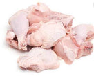 Raw chicken pieces including drumsticks, thighs, and wings on a white background