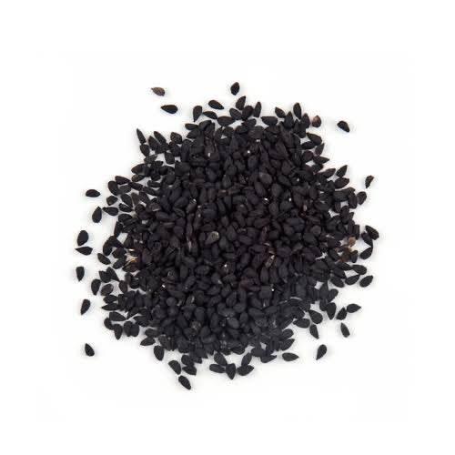 Close-up of a pile of small black seeds on a white background, natural texture