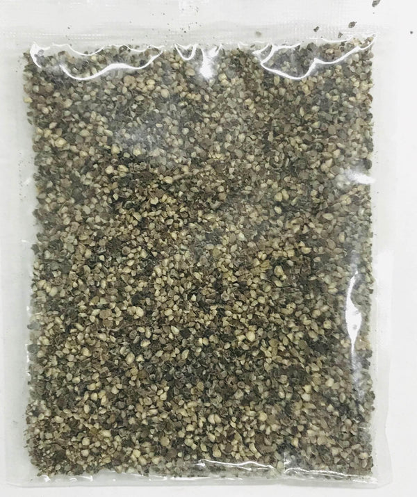 Clear plastic bag filled with coarse ground black peppercorns on white background