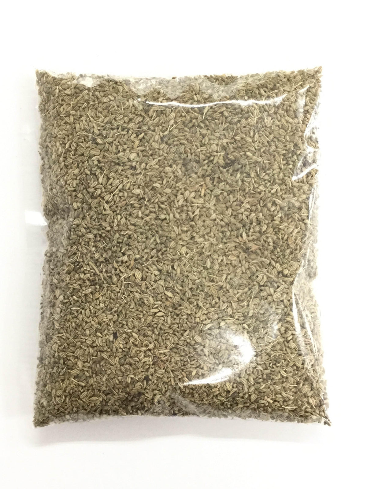 Clear plastic bag filled with small brownish dried seeds, isolated on white background