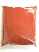 Clear plastic bag filled with finely ground red chili powder spice