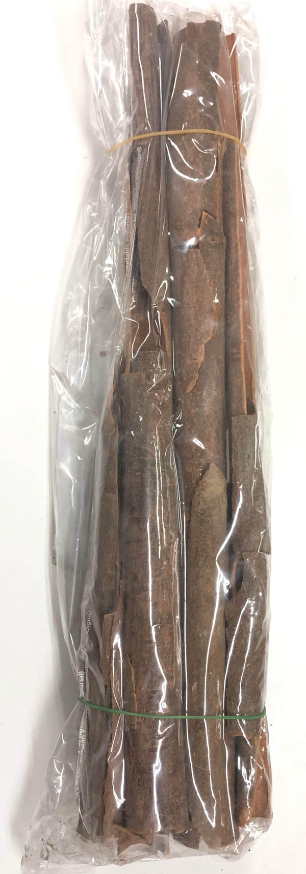 Bundle of cinnamon sticks wrapped in plastic with rubber bands on a white background