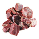 pile of raw beef oxtail chunks with marbled fat on white background