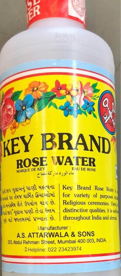 Key Brand Rose Water bottle with colorful floral design on yellow label, manufactured by A.S. Attarwala & Sons, Mumbai